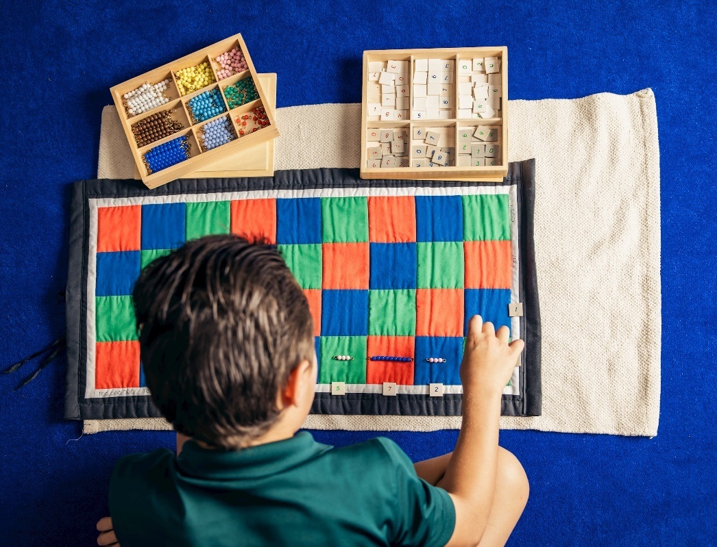 child learning math through Montessori materials